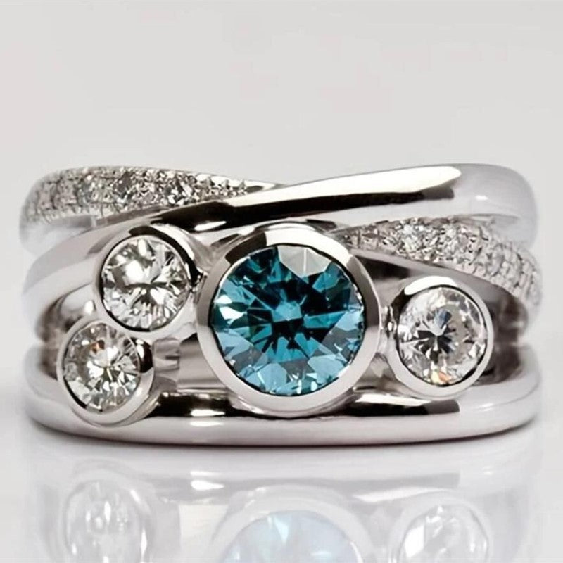 Baroque silver-tone hollow ring with blue rhinestones